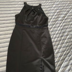 Black above the knee dress with slit over left leg.